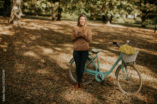 Young woman with bicycle us...