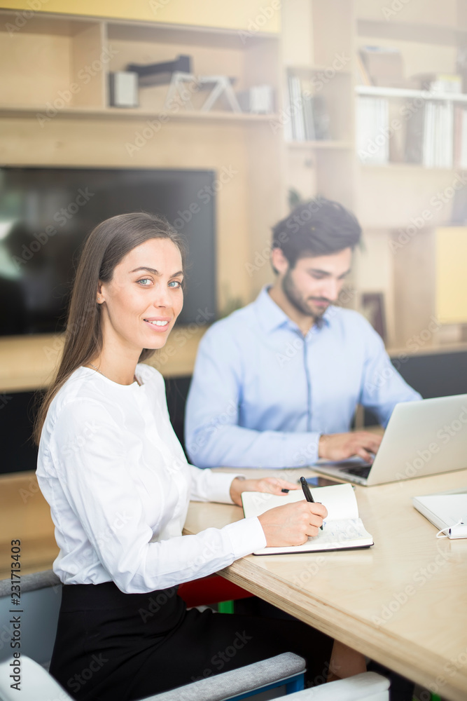 Two business people discussing new project in modern office Two business people discussing new project in modern office