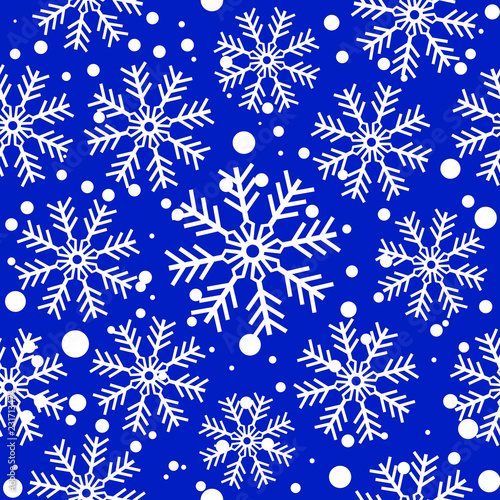 White snowflakes over blue. Seamless vector background.