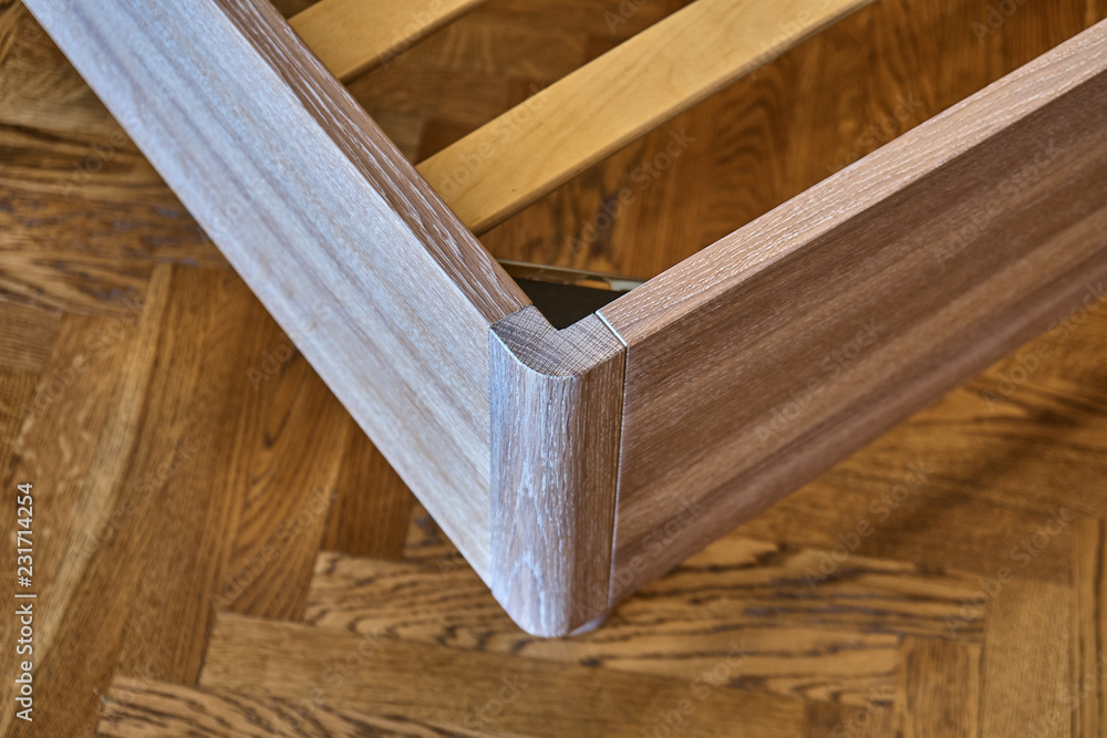 Solid wood bed. Modern scandinavian style. Close-up. Empty bedroom Solid wood bed. Modern scandinavian style. Close-up. Empty bedroom