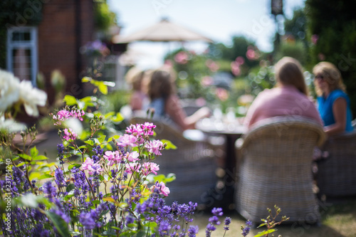 People enjoying drink in English pub Garden