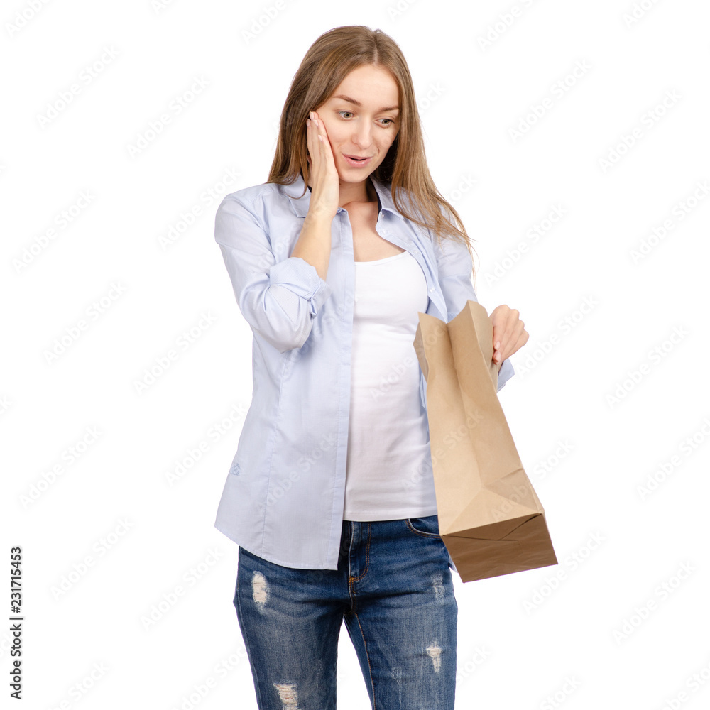 Woman holding a paper bag package shopping beauty on a white background. Isolation Woman holding a paper bag package shopping beauty on a white background. Isolation