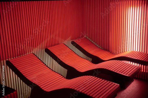 Red light colored empty sauna chairs