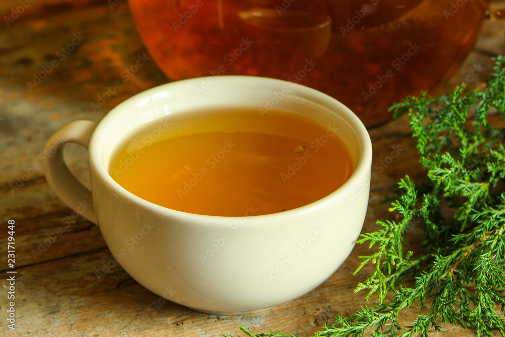 tea in a transparent teapot on the table (herbal tea is brewed). top view. tea in a transparent teapot on the table (herbal tea is brewed). top view.
