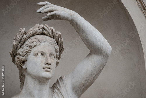 Statue of sensual Roman renaissance era woman in circlet of bay leaves, Potsdam, Germany, details, closeup photo