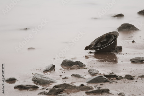 World War era Brodie helmet on beach.
