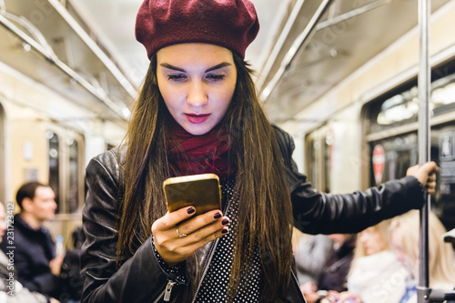 Photography Woman with phone travelling by metro in Moscow