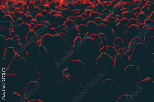 Colorful crowd of people of a big music festival in a stage lights as a beautiful background