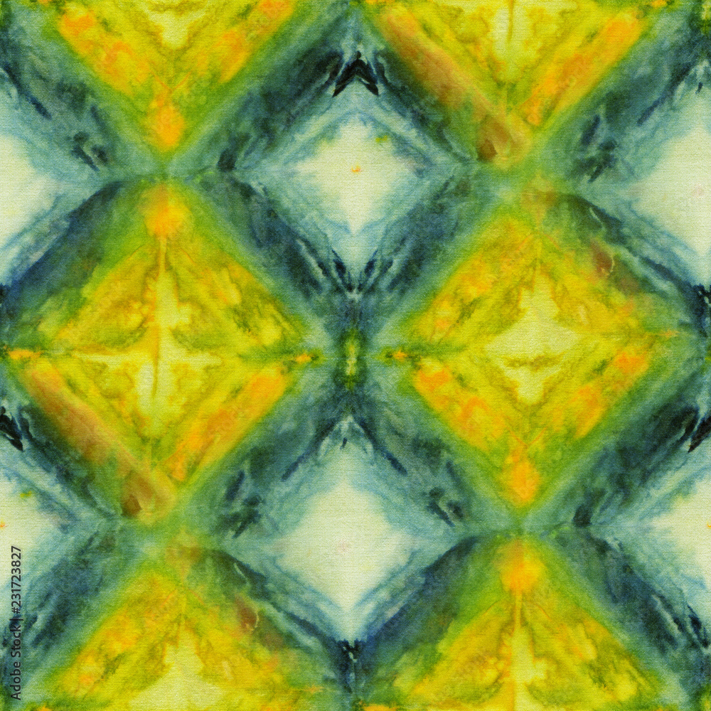 Seamless tie-dye pattern of yellow and green color on white silk. Hand painting fabrics - nodular batik. Shibori dyeing. 