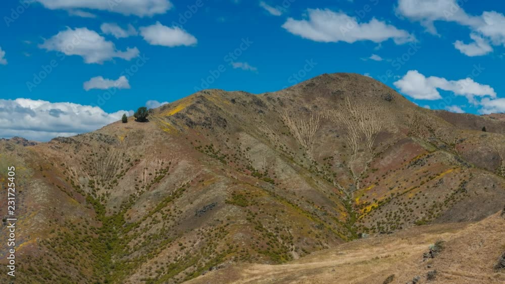 Timelapse video of beautiful arid mountain on sunny summer day with scattered clouds. Shot in Central Otago, New Zealand Timelapse video of beautiful arid mountain on sunny summer day with scattered clouds. Shot in Central Otago, New Zealand