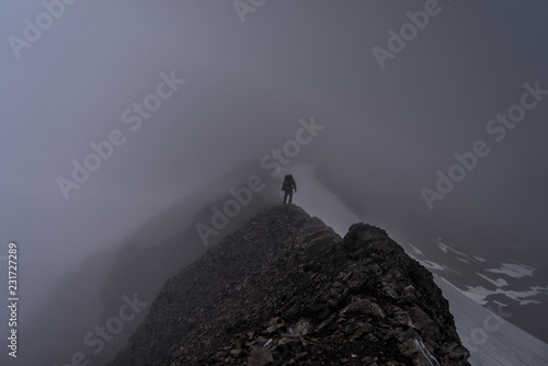 Hiker in the Canadian Rockies. Stormy weather in Peter Lougheed Provincial Park, Alberta. Taken from the famous Northover Ridge route