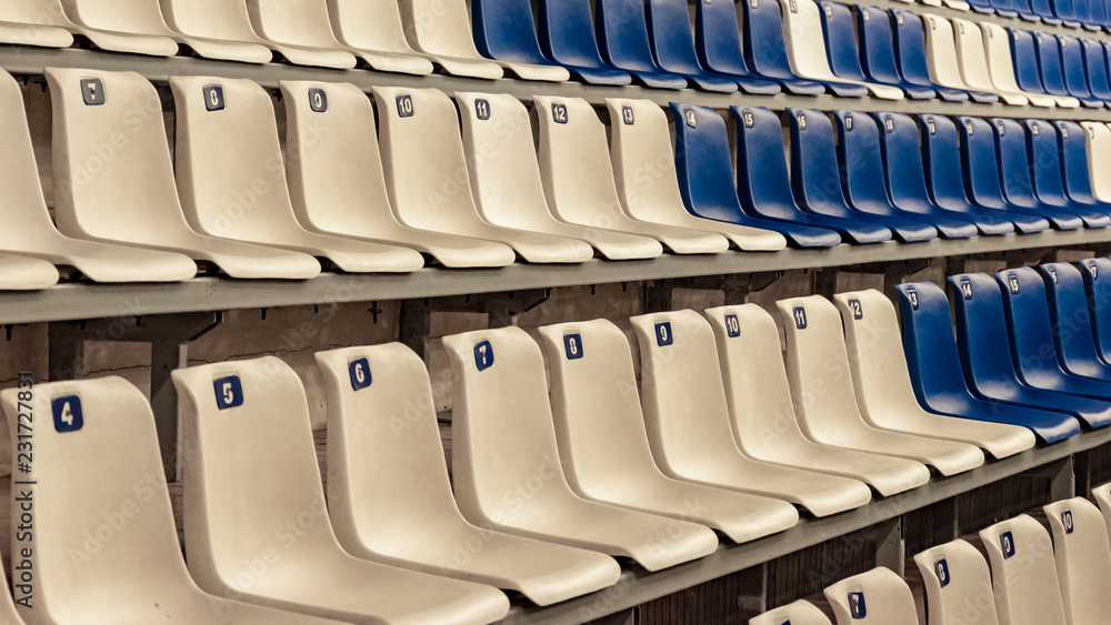 Fototapeta premium Empty white and blue seats in the stadium