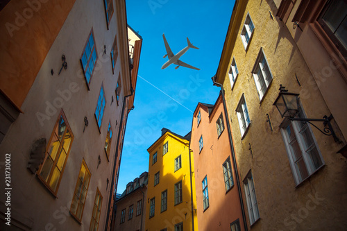Photography plane flies over the houses of the city over Stockholm.