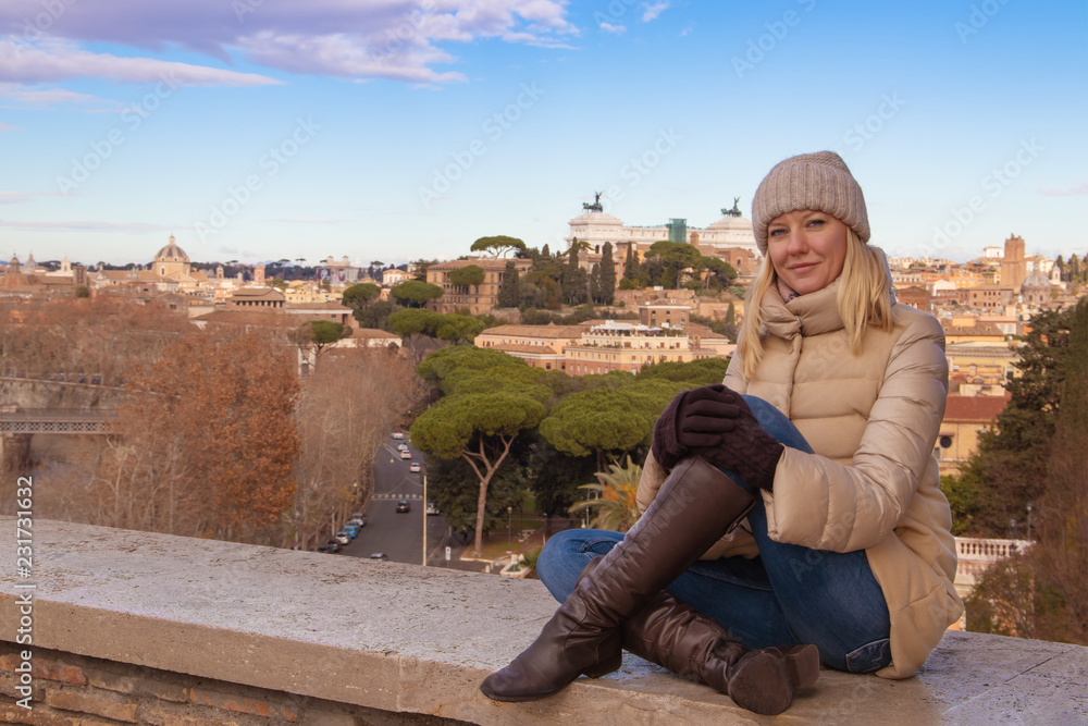 Portrait of a happy young blond woman against the background of Rome Italy.