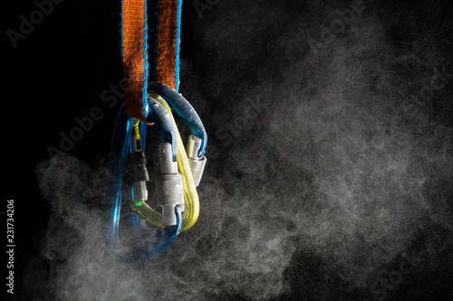 Blue and yellow rock climbing carabiners and chalk