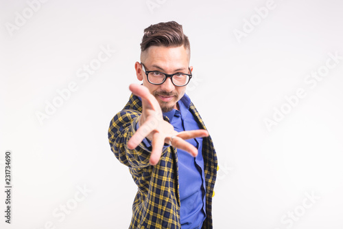 People and gesture concept - young man invite you to go with him, smiling, wearing glasses photo