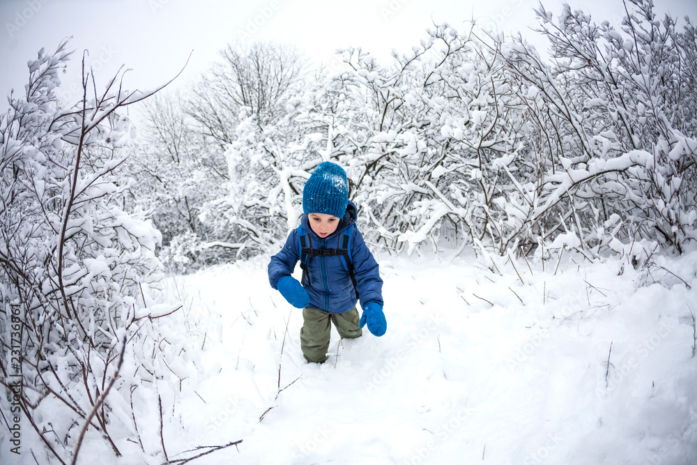 A child runs through the snow.