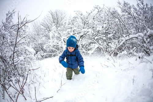 A child runs through the snow.