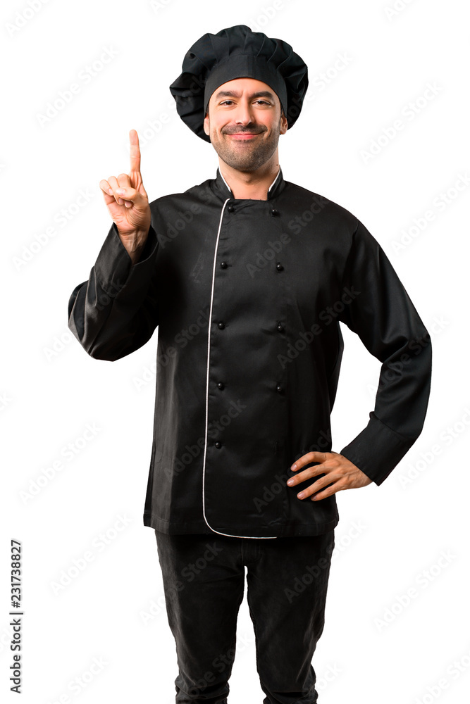Chef man In black uniform showing and lifting a finger in sign of the best on isolated white background Chef man In black uniform showing and lifting a finger in sign of the best on isolated white background
