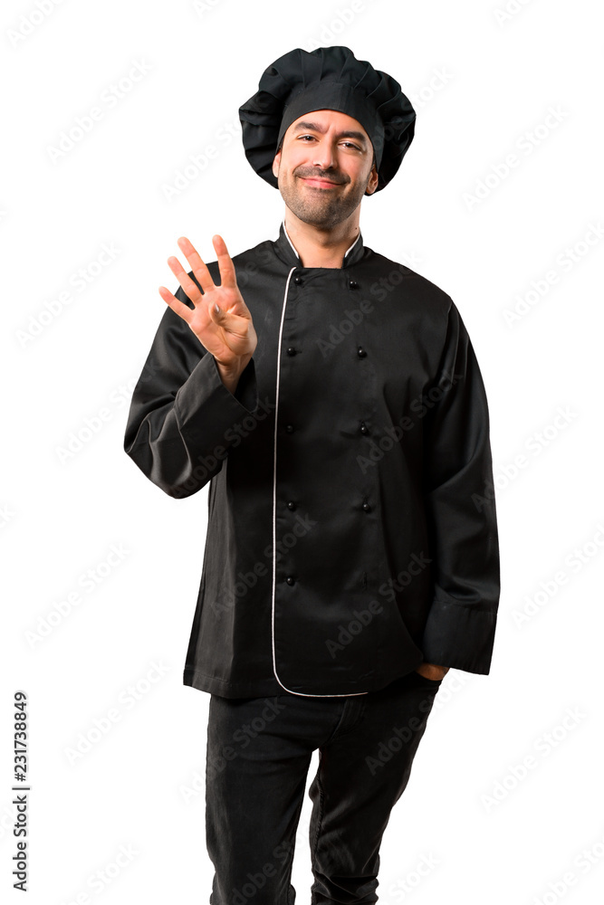 Chef man In black uniform happy and counting four with fingers on isolated white background Chef man In black uniform happy and counting four with fingers on isolated white background