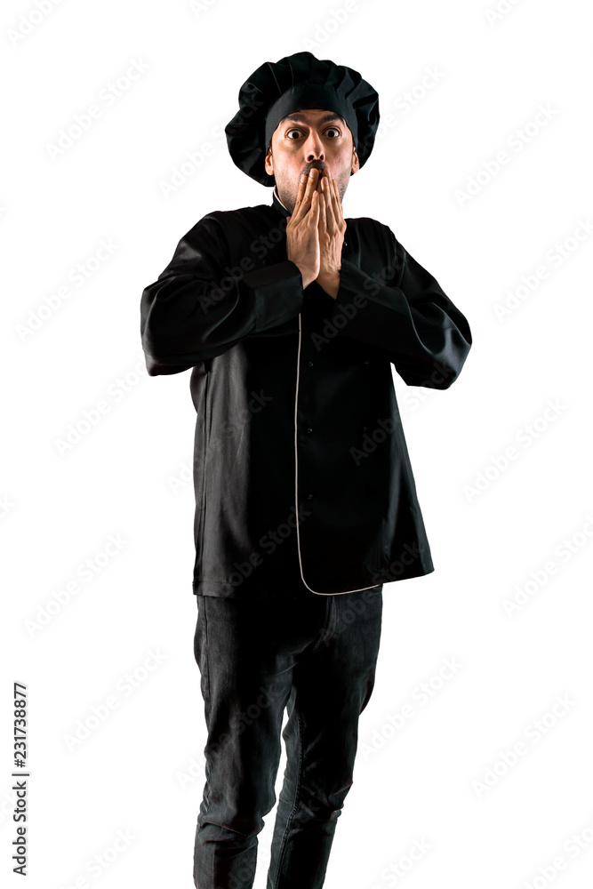 Chef man In black uniform with surprise and shocked facial expression on isolated white background Chef man In black uniform with surprise and shocked facial expression on isolated white background