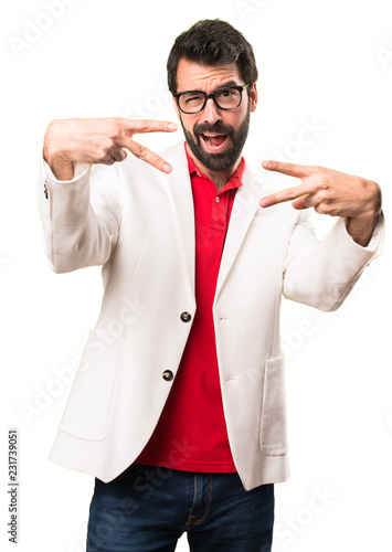 Brunette man with glasses making victory gesture on white background