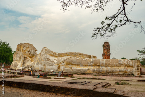 Statue of the big sleeping Reclining Buddha in Wat Lokayasutharam Temple, Ayutthaya, Thailand, front view without people photo