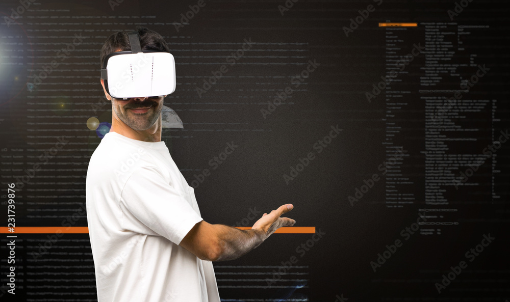 Naklejka premium Man using VR glasses pointing back inside the virtual reality mode