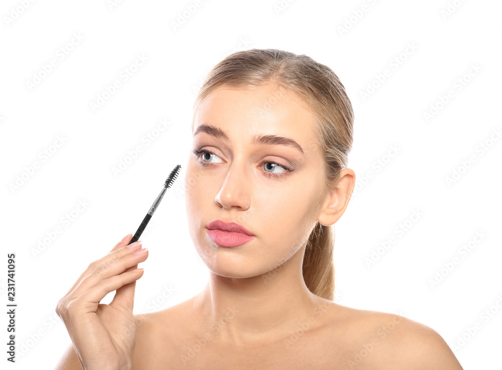 Portrait of young woman with beautiful natural eyelashes holding brush on white background Portrait of young woman with beautiful natural eyelashes holding brush on white background