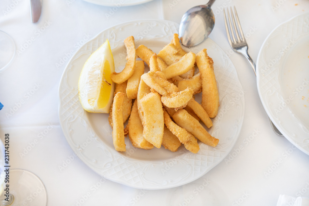 aerial view of white dish with fried squid big pieces aerial view of white dish with fried squid big pieces