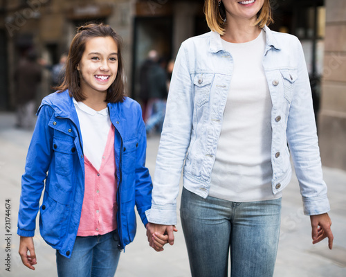 Mother and daughter walking photo