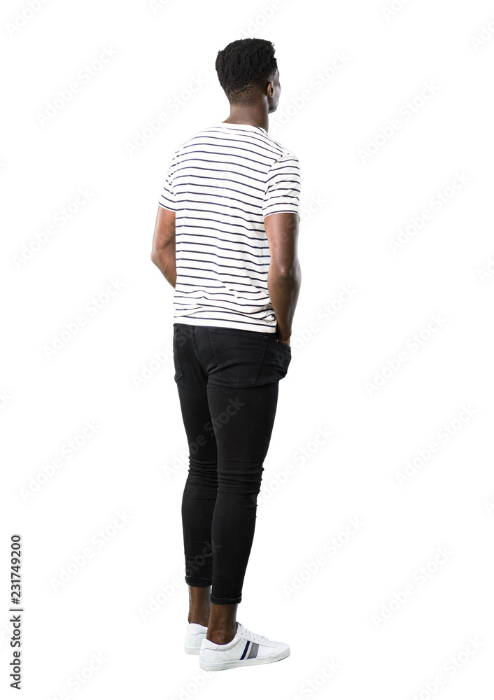 Full body of Dark skinned man with striped shirt looking back on white background Full body of Dark skinned man with striped shirt looking back on white background