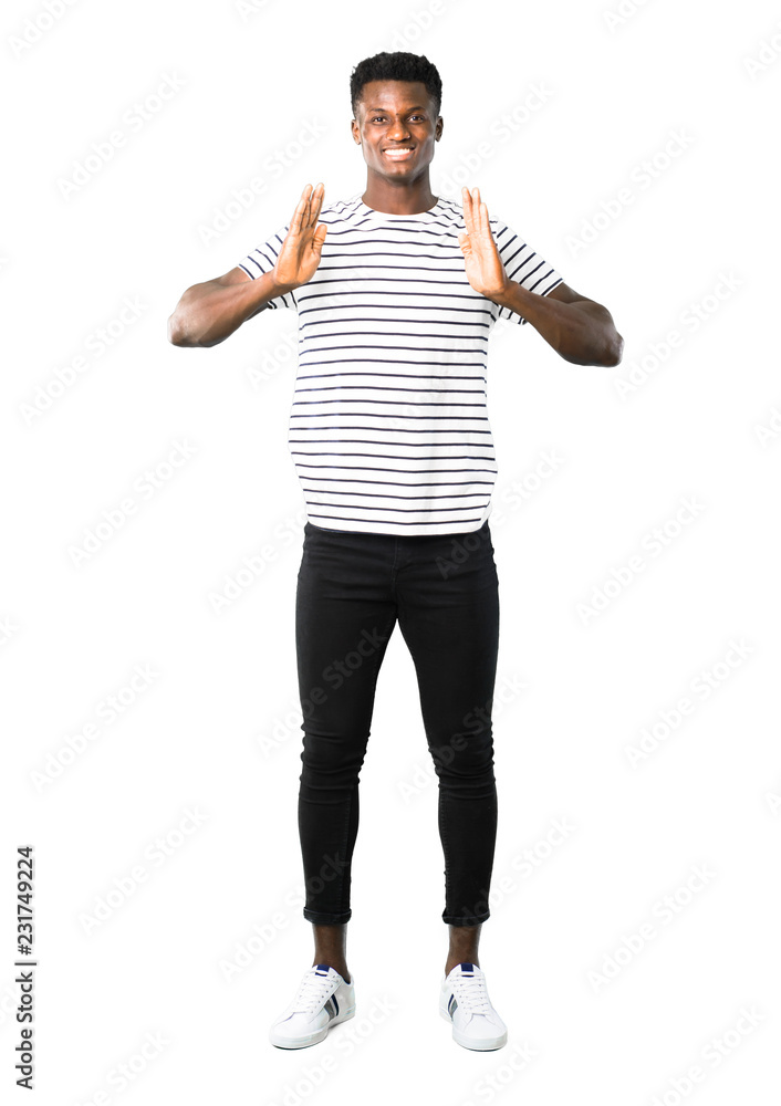 Full body of Dark skinned man with striped shirt holding copy space imaginary on the palm to insert an ad on white background Full body of Dark skinned man with striped shirt holding copy space imaginary on the palm to insert an ad on white background