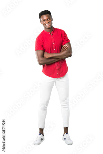 Full body of Young african american man keeping the arms crossed while smiling on white background