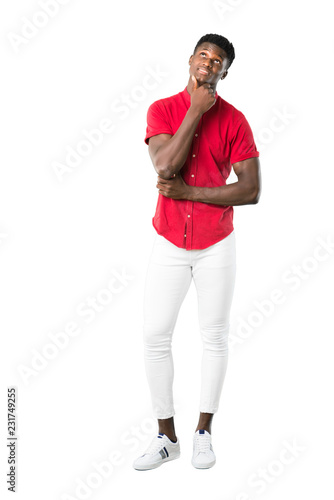Full body of Young african american man standing and thinking an idea on white background