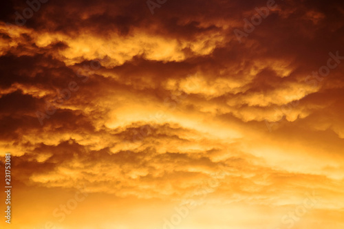 romantic sunset sky with golden clouds