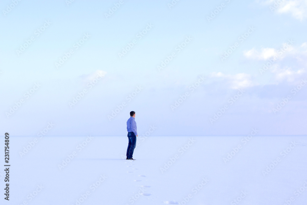 deadpan man standing shore frozen sea downshifting way relaxes winter seascape