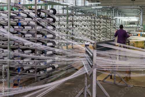 Workers, fiberglass mesh making machine, building materials for wall insulation photo
