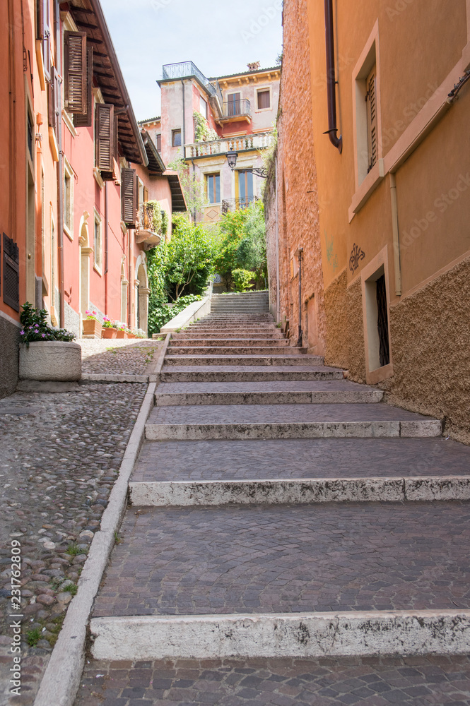 Narrow Verona strees to Castel San Pietro during summer season