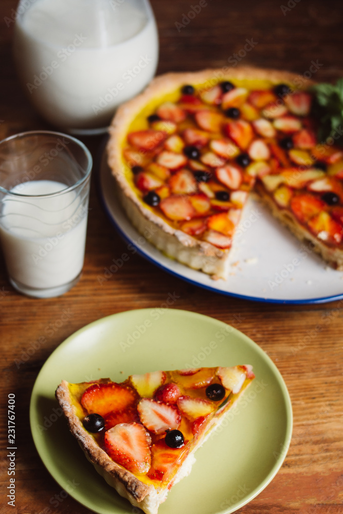 Homemade pies with jam and glass of milk on on an vintage wooden table Homemade pies with jam and glass of milk on on an vintage wooden table