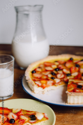 Homemade pies with jam and glass of milk on on an vintage wooden table