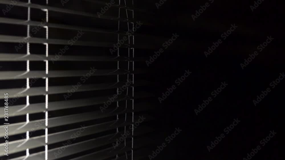 On the side, the jalousie open and light appears in the room. Black background On the side, the jalousie open and light appears in the room. Black background