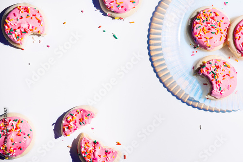 Pink iced cookies with sprinkles photo
