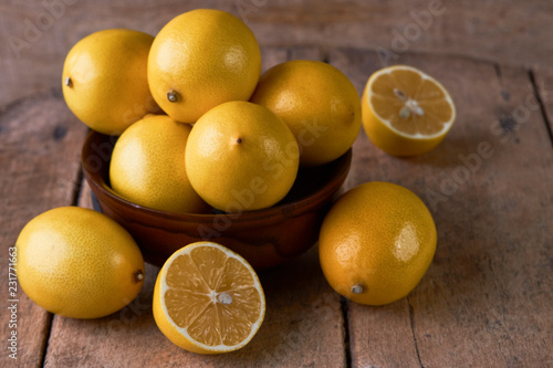 Fresh Juicy Lemon cut on wooden table, close-up. 