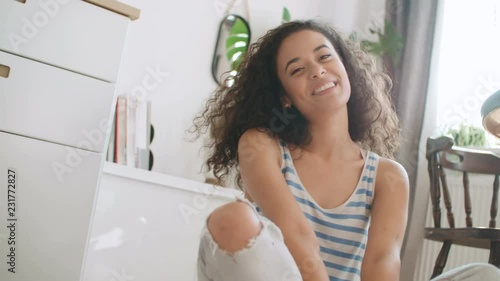 Portrait of a beautiful young woman smiling at the camera.