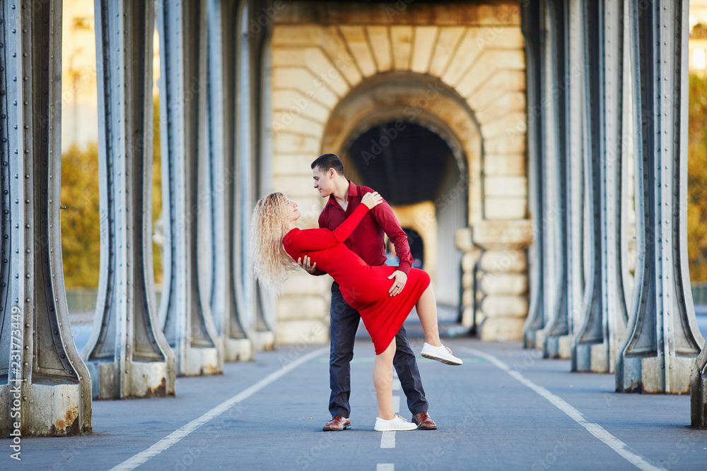 Romantic couple kissing on Bir-Hakeim bridge in Paris, France