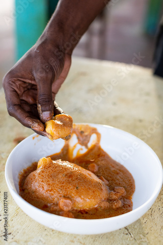 Person grabbing a piece of a fufu photo