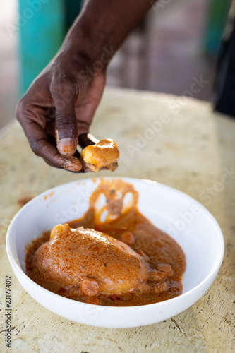 Person holding a piece of a fufu photo