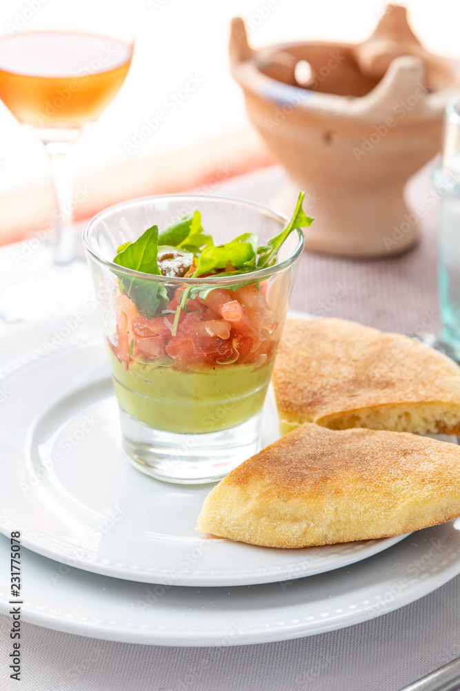 A layered dip with bread and a drink A layered dip with bread and a drink