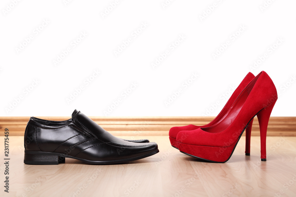 Man's and woman's shoes in front of each other Man's and woman's shoes in front of each other